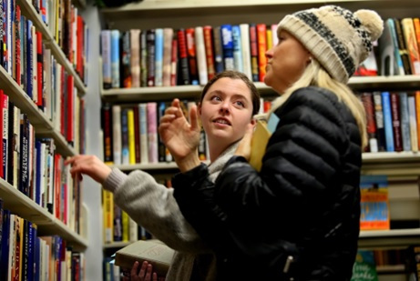 Celeste Rooney, right, and her daughter Etain search the shelves of the Friends Book  Shop at the Central Library in Virginia Beach. STEPHEN M. KATZ/STAFF photos